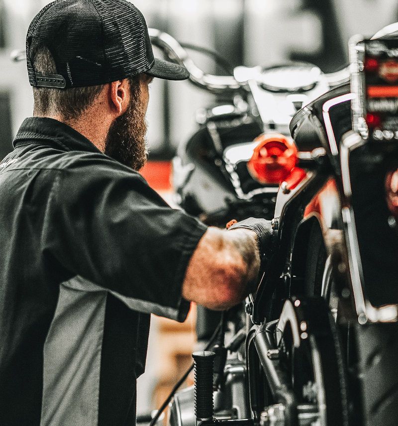 Adventure Harley-Davidson® service team members working on a motorcycle